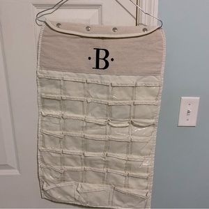 “B” monogrammed jewelry holder, various sized pockets